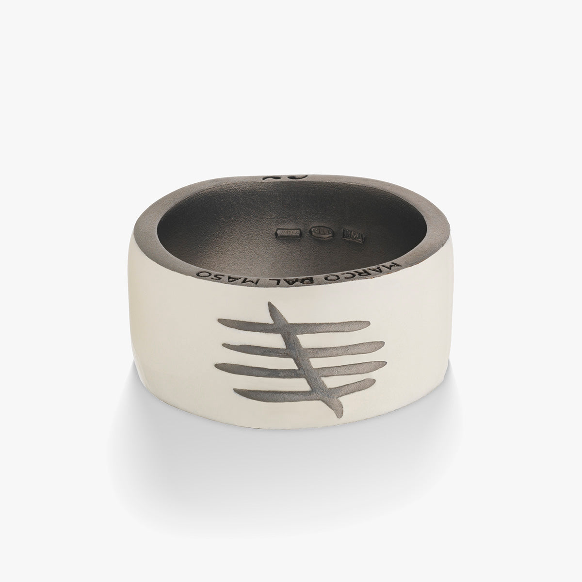 Silver ring with engraved design on a white background
