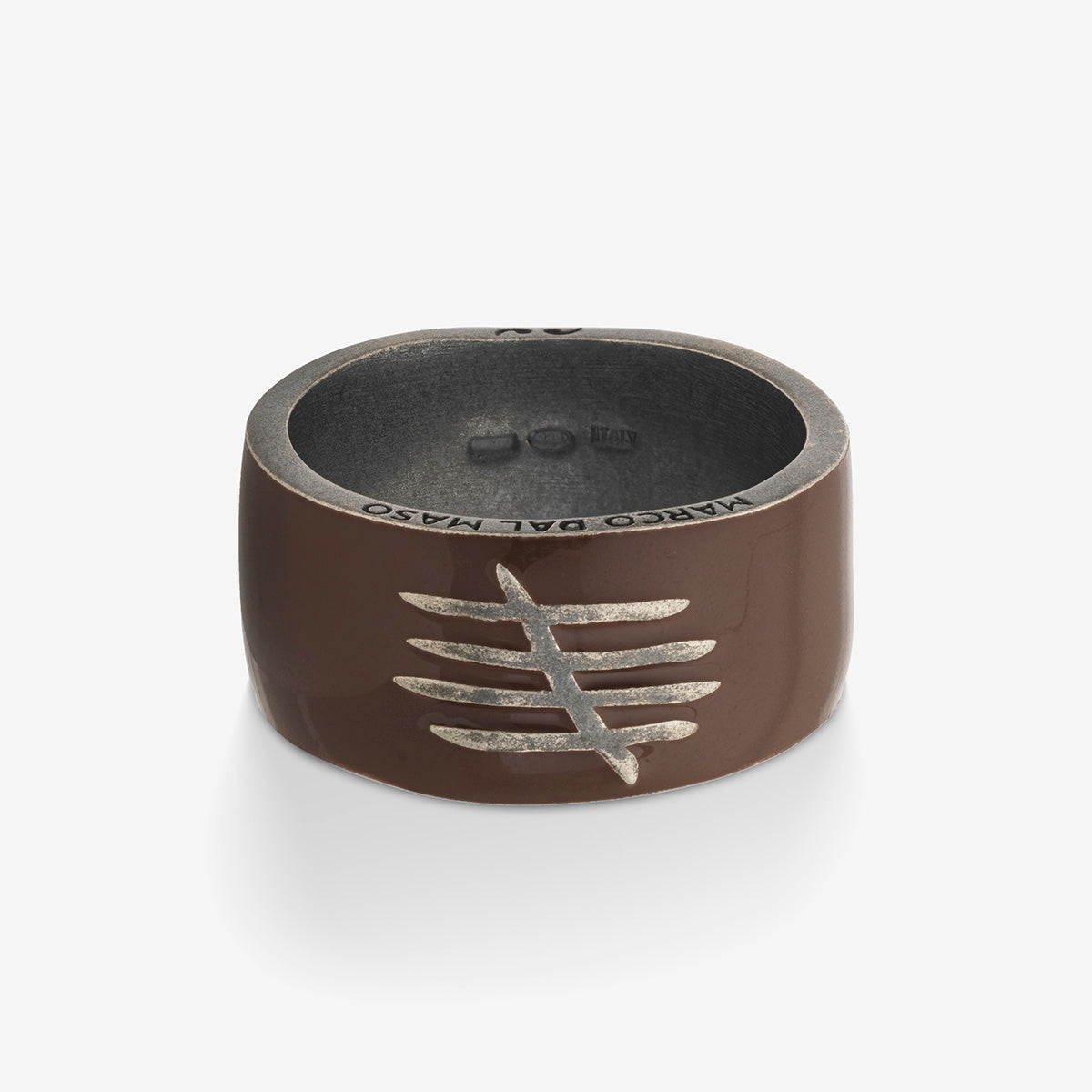 Brown ring with a silver design on a white background