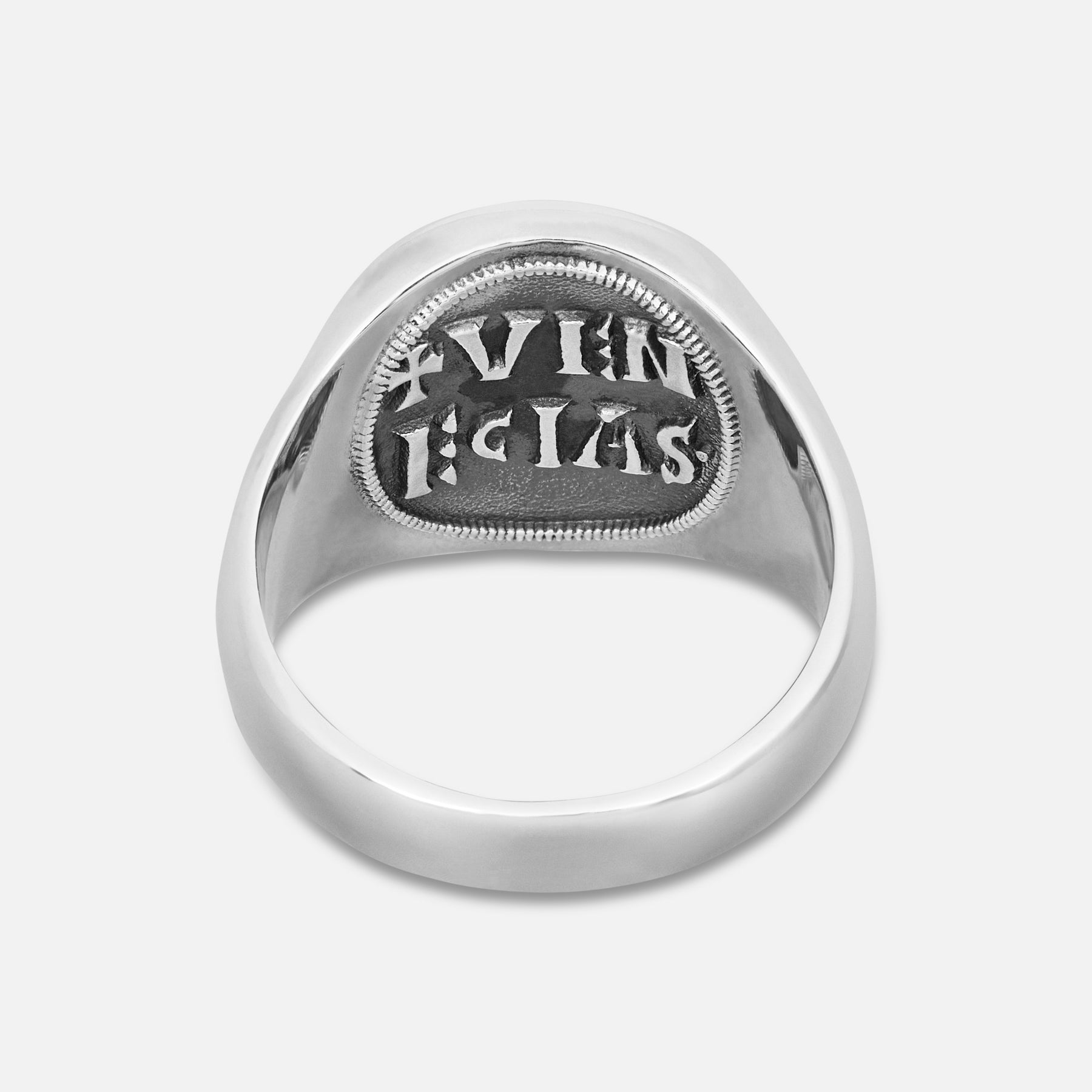 Silver ring with engraved text on a white background