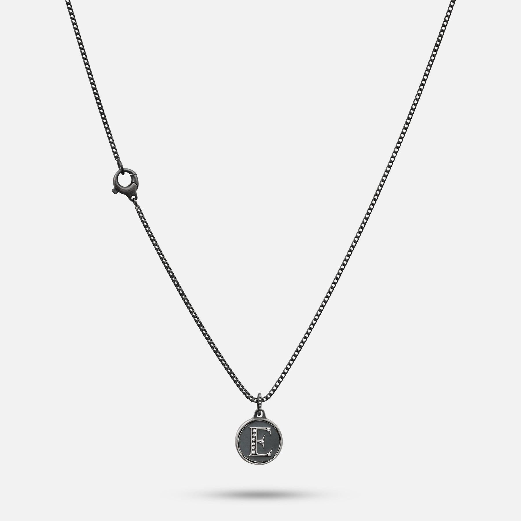Necklace with a round pendant on a light gray background