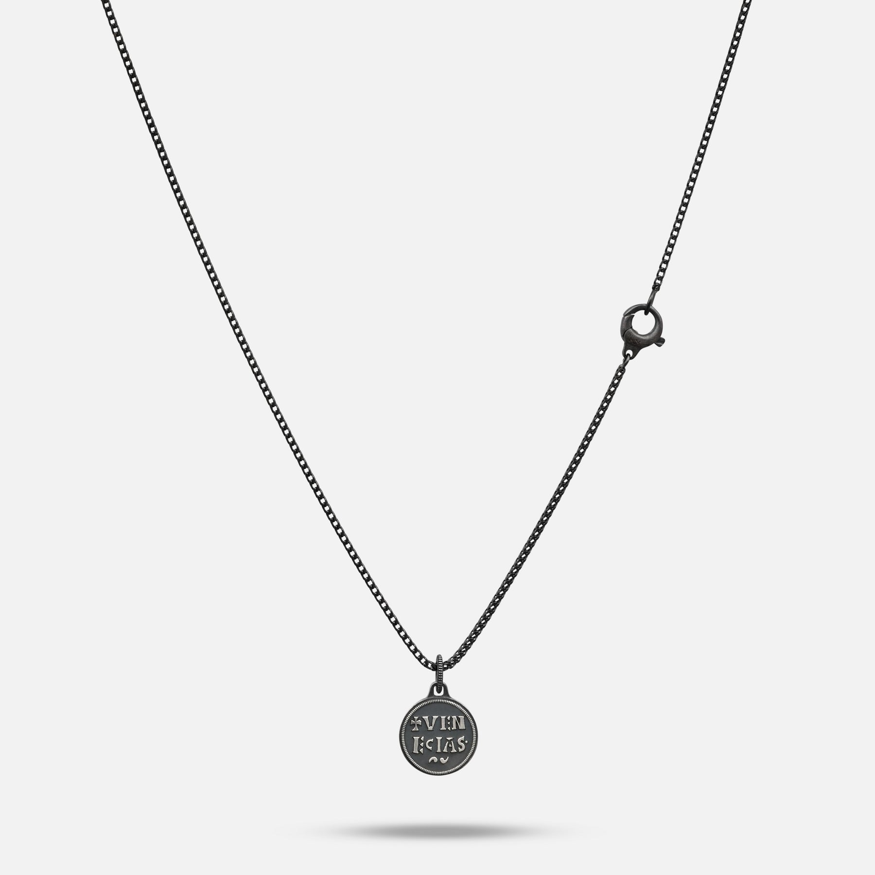 Necklace with a round pendant on a light gray background