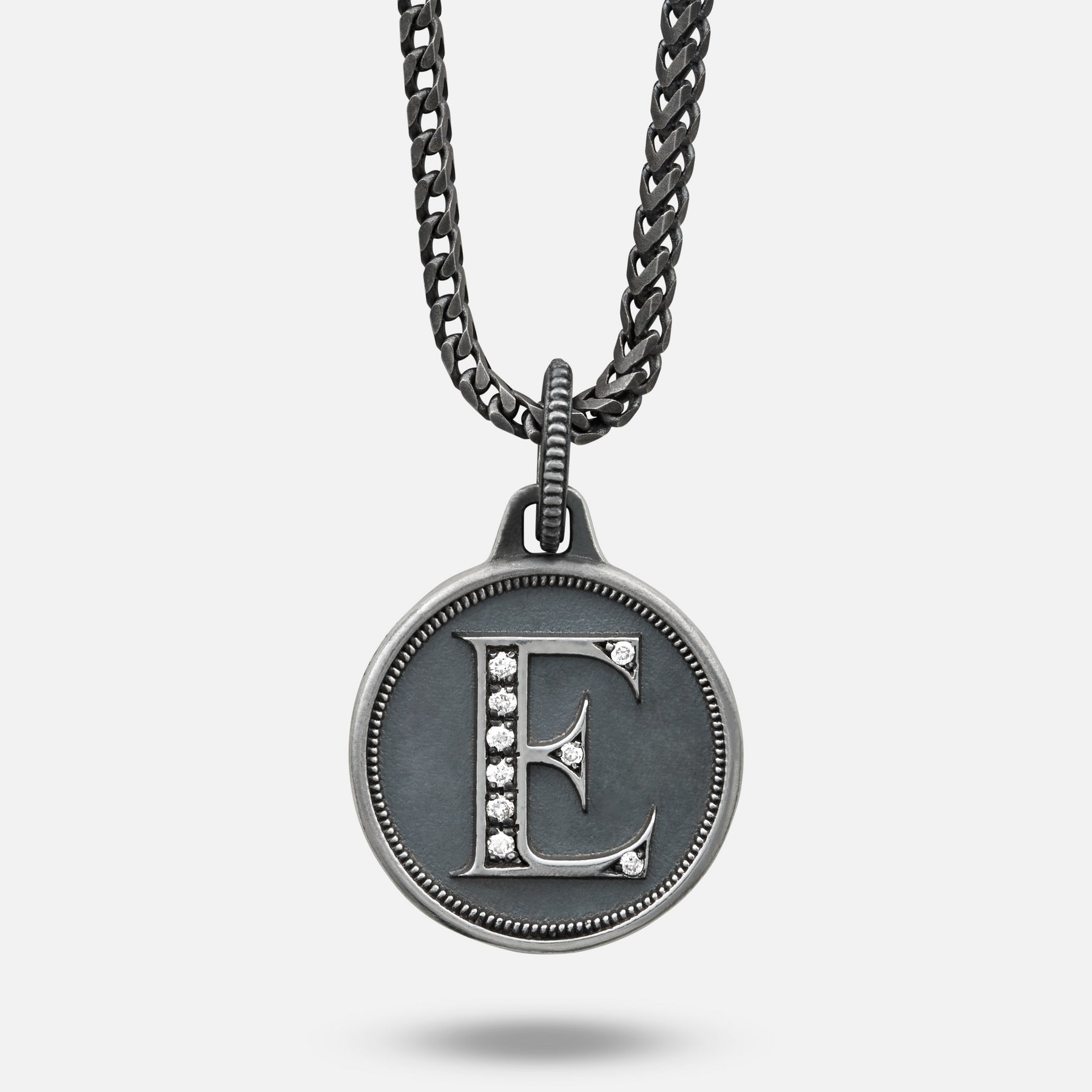 Necklace with a pendant featuring the letter 'E' on a light gray background