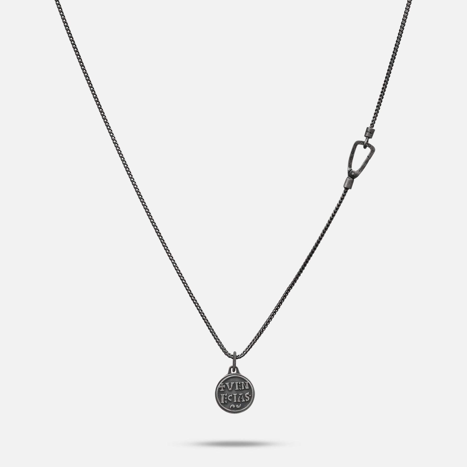 Silver necklace with a pendant on a light gray background