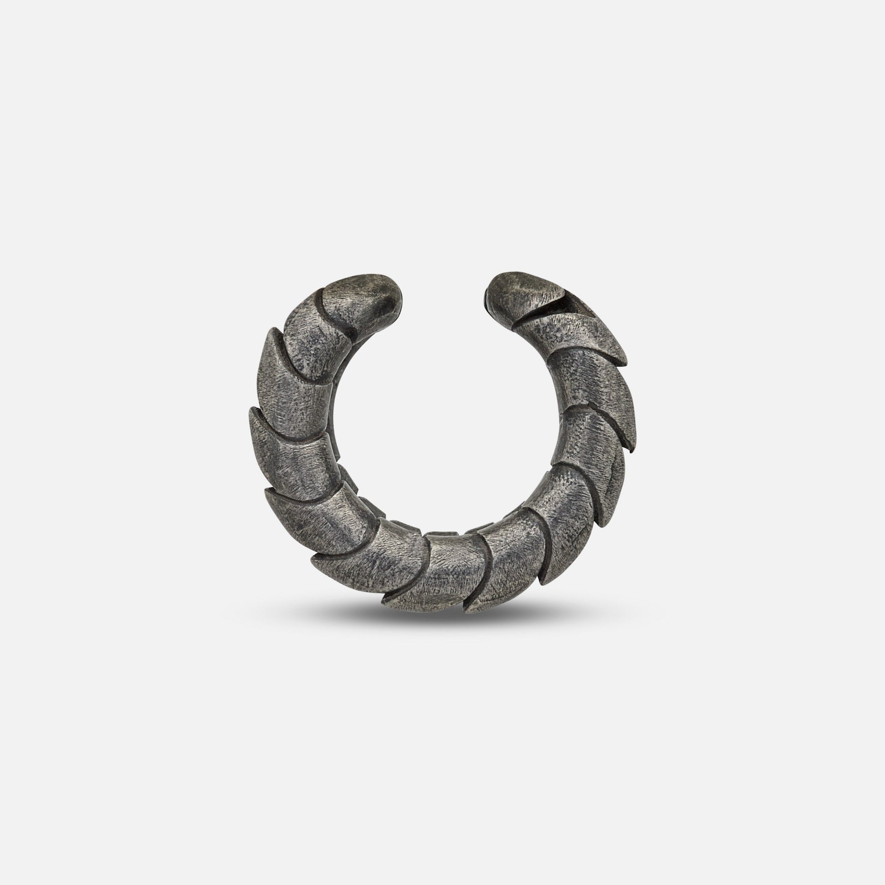 Side view of Iron Snake ear cuff in oxidized silver on display.