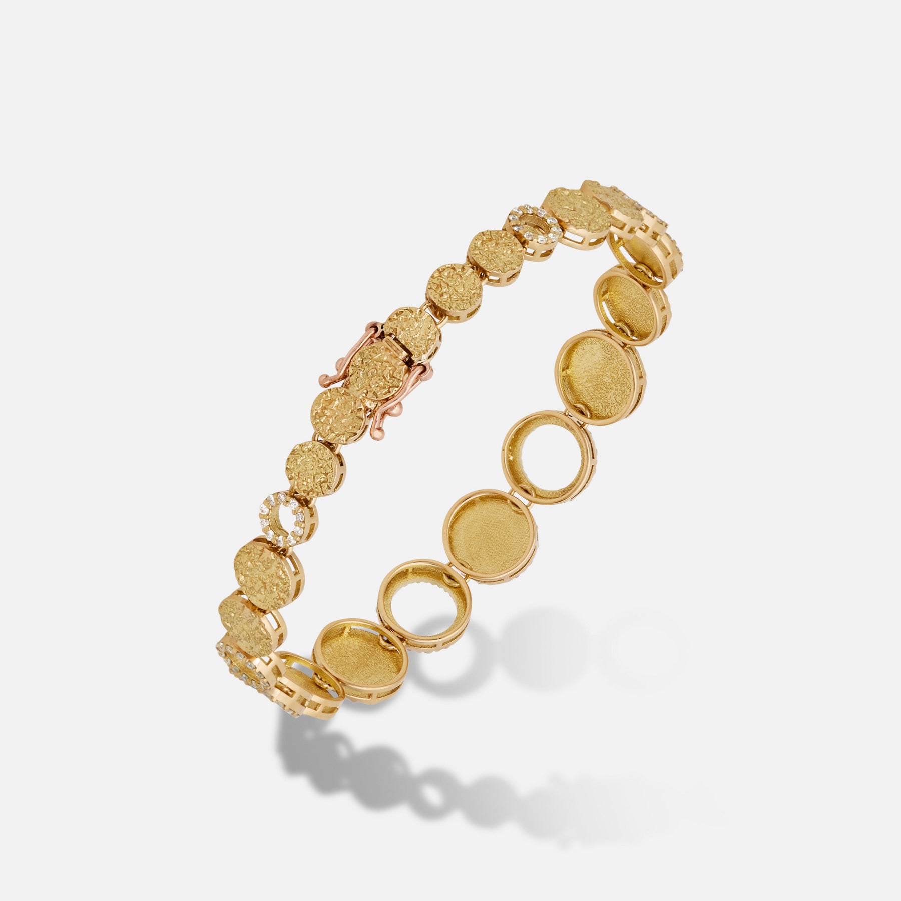 Frammenti Yellow Gold and White Diamonds Bracelet featuring matte 18K gold and pavé white diamonds in a sculptural circular design.