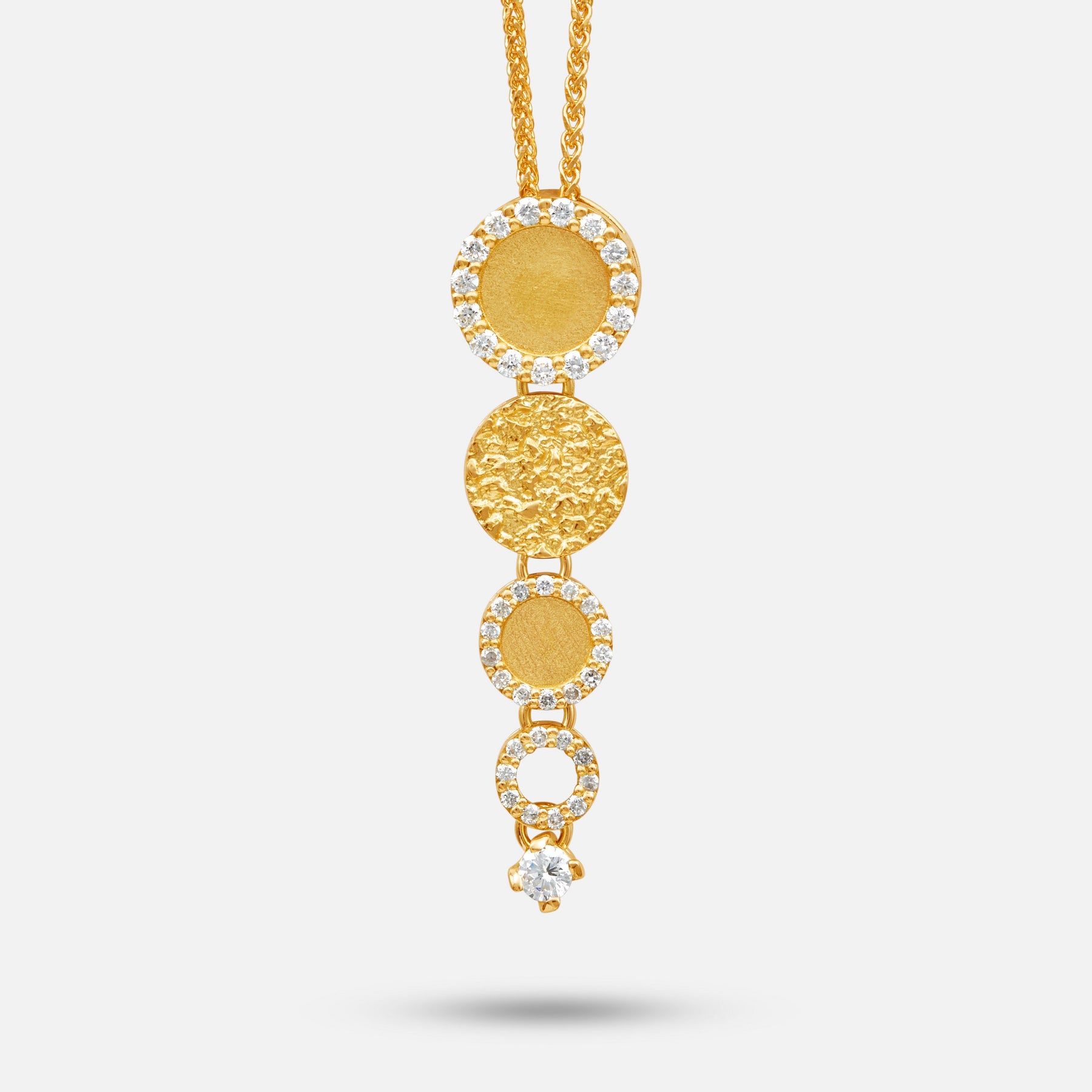 Frammenti Cascade pendant in 18K yellow gold with descending circular diamond‑set discs.