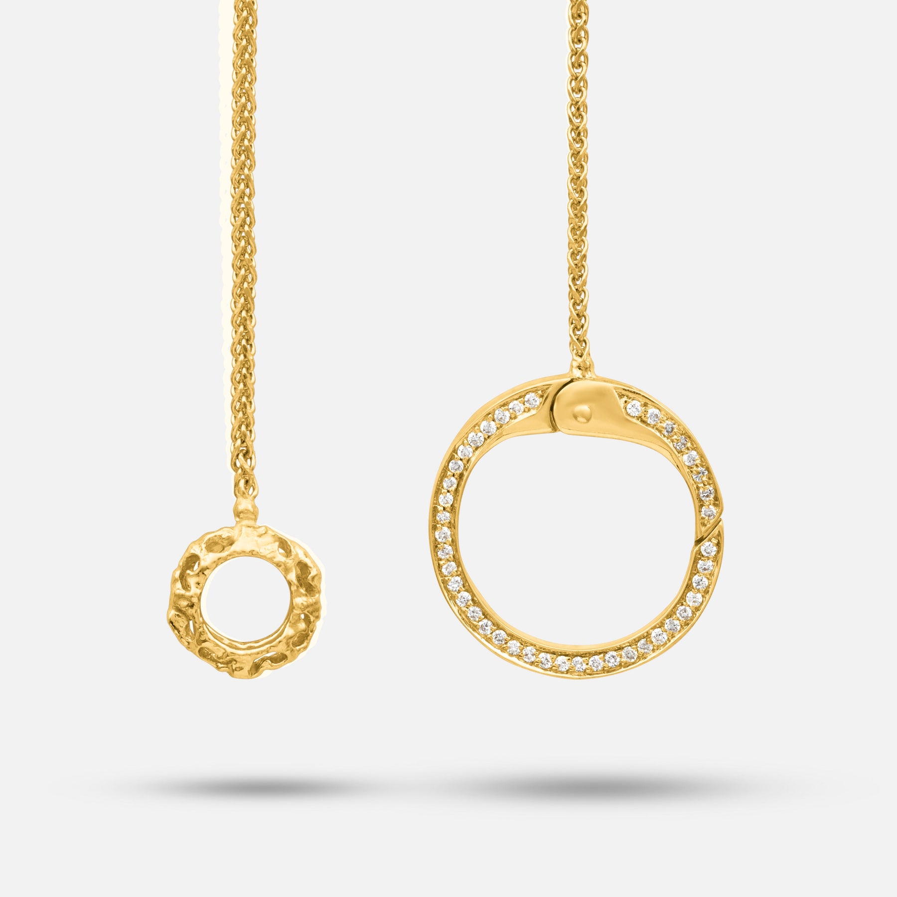 Frammenti Cascade Pendant in matte 18K yellow gold with white diamonds, featuring layered circular elements in a vertical drop.