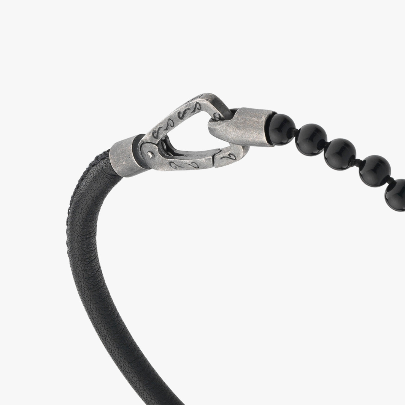 Bracelet with black beads and silver clasp on a white background