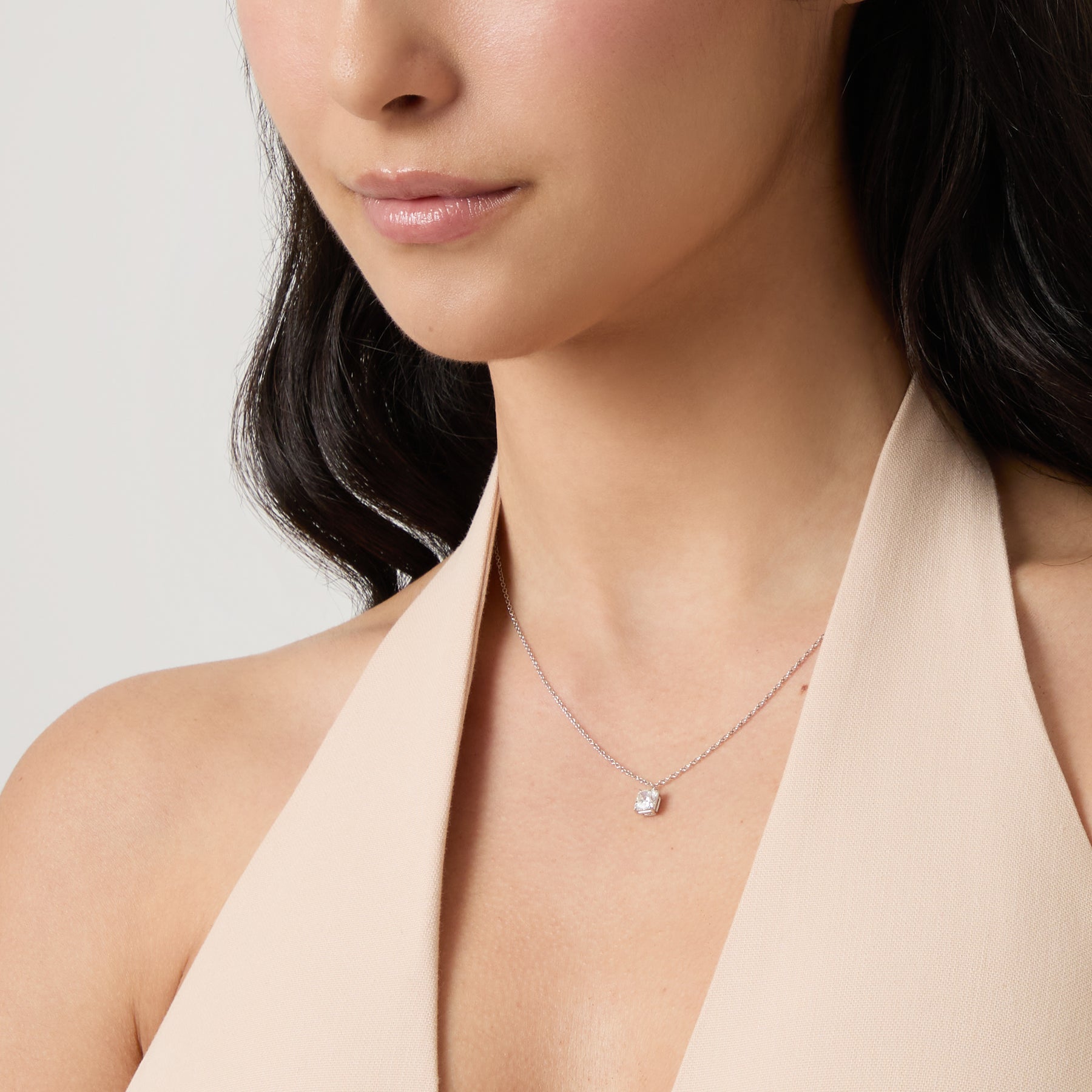 Eclipse Celeste Pendant worn alone by model against neutral background