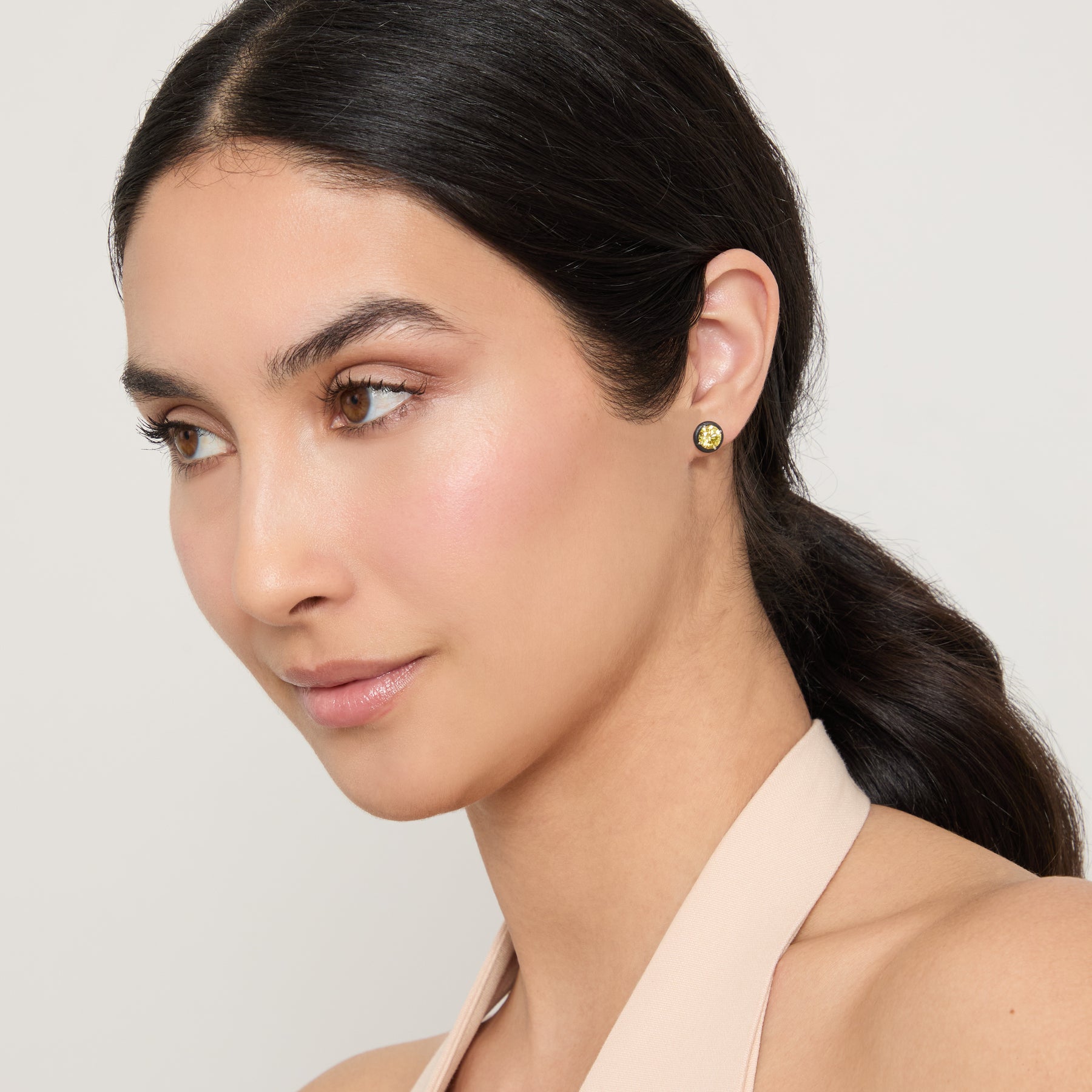 Eclipse Black Luna Earrings worn alone by model against neutral background