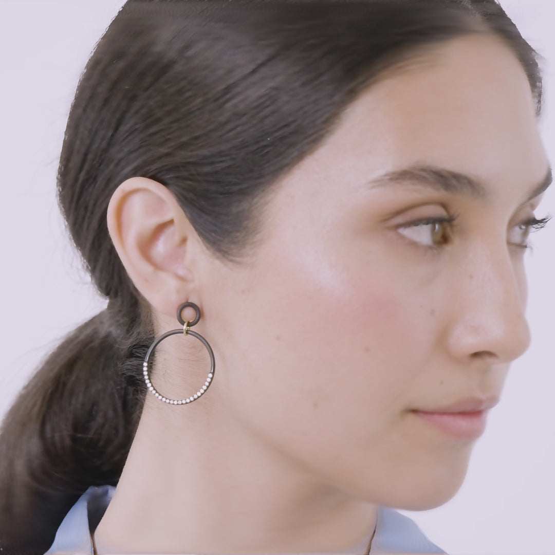 Eclipse Twin Orbit Earrings shown in motion to highlight detail and finish