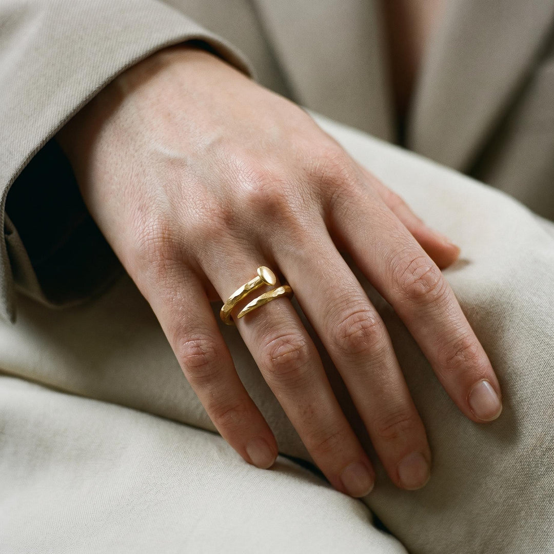 Forged Transcendence Gold Ring in 18k yellow gold worn on the hand.