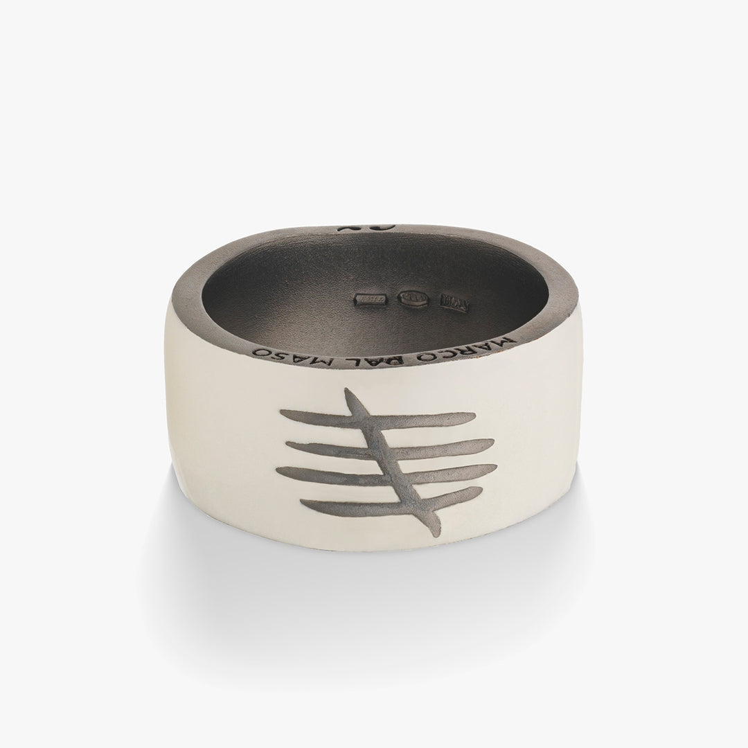 Silver ring with engraved design on a white background