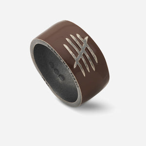 Brown ring with a silver design on a white background