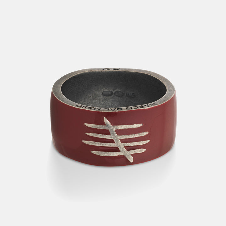 Red ring with silver design on a white background