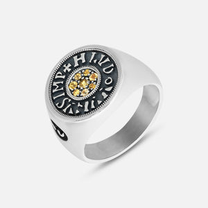 Silver ring with yellow gemstones on a white background