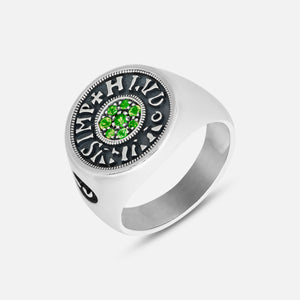 Silver ring with green gemstones on a white background