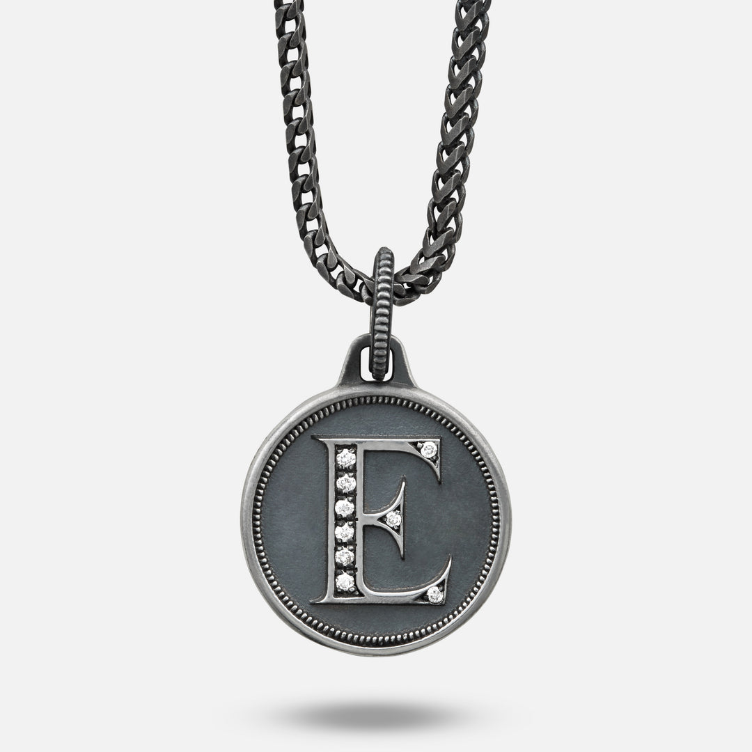 Necklace with a pendant featuring the letter 'E' on a light gray background