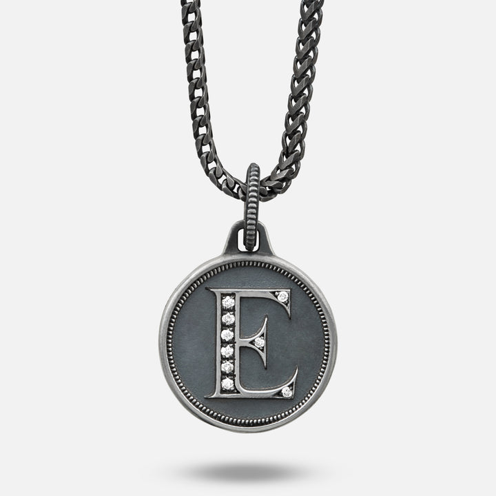 Necklace with a pendant featuring the letter 'E' on a light gray background