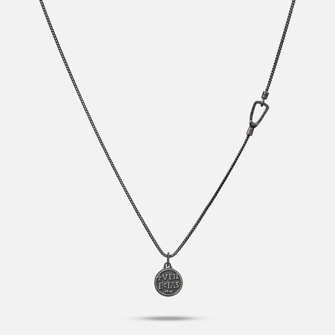 Silver necklace with a pendant on a light gray background