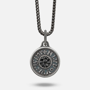 Silver pendant necklace with chain on a light gray background