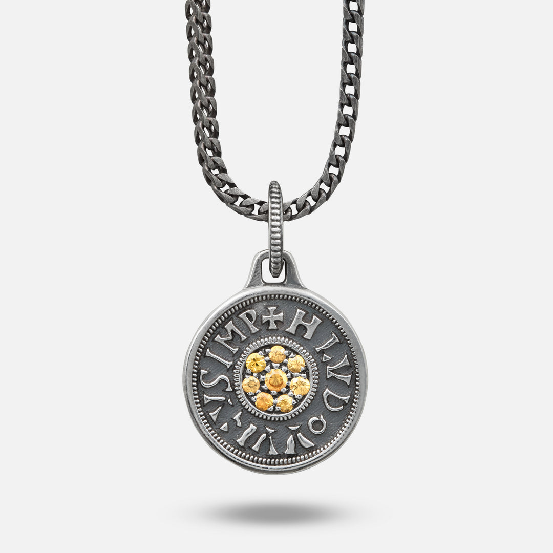 Silver pendant necklace with a chain on a white background