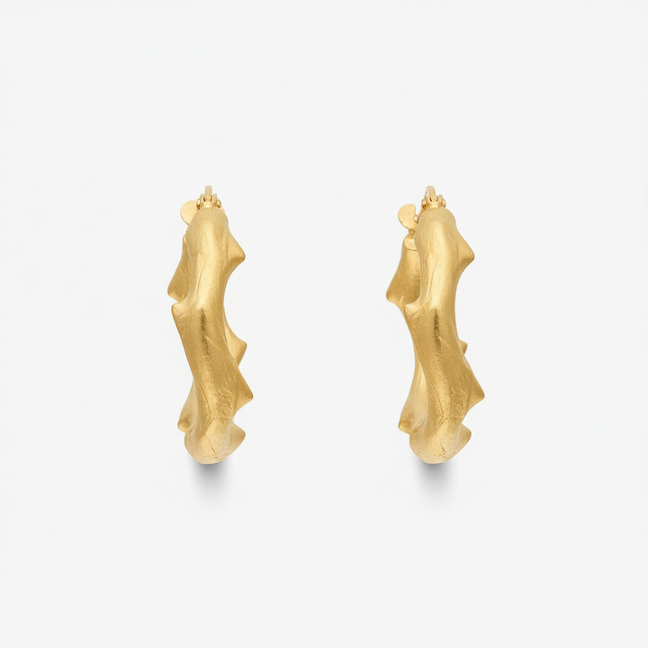Gold earrings on a white background