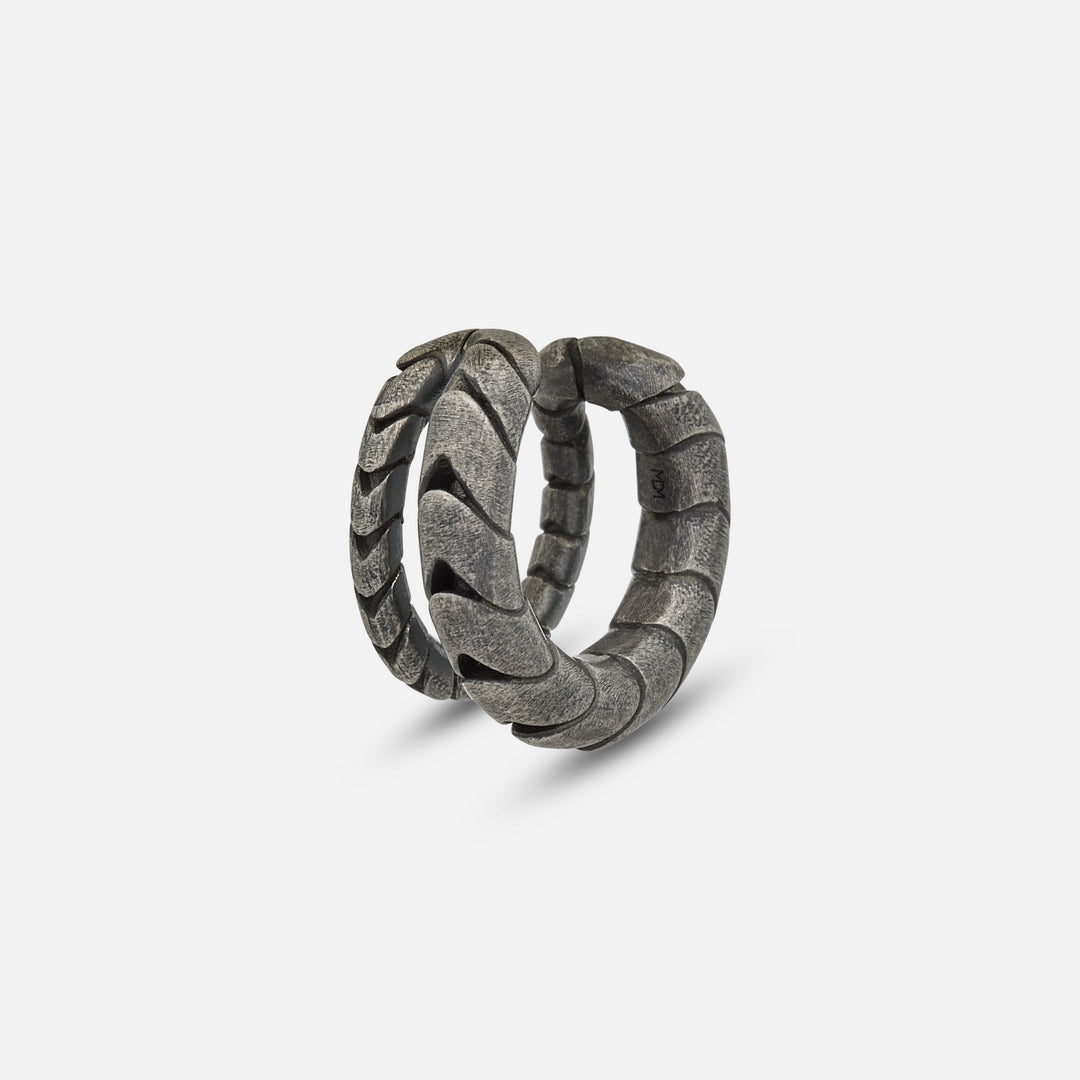 Close-up of oxidized silver Iron Snake ear cuff with sculpted curve.