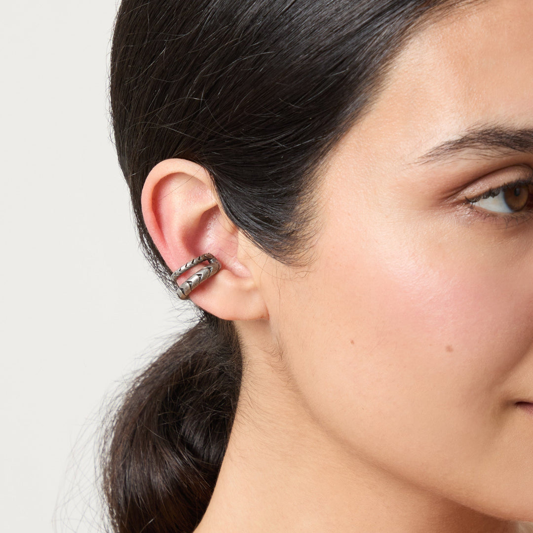 Model wearing the Iron Snake ear cuff in oxidized silver.