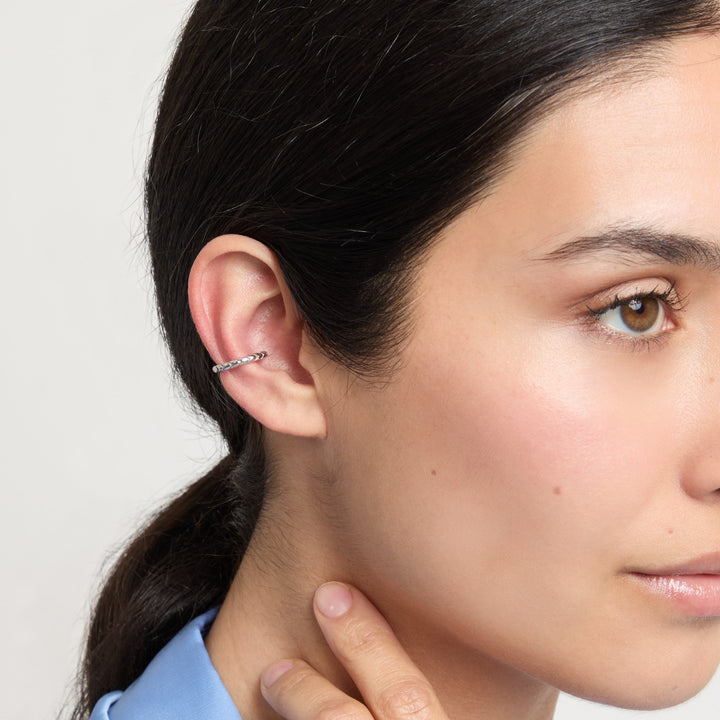 Model wearing Iron Snake Slender Ear Cuff in polished silver.