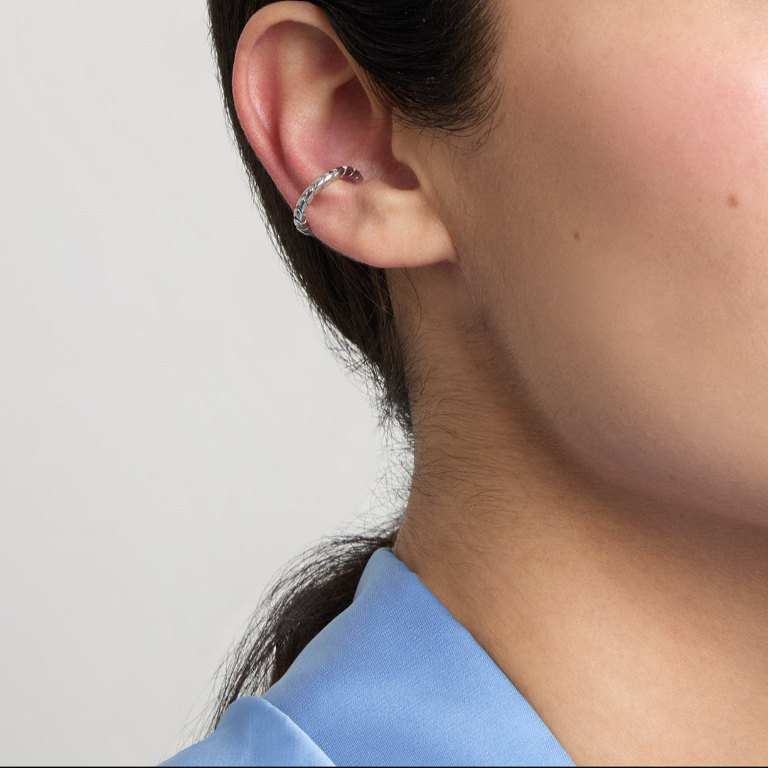 Model wearing Iron Snake Slender Ear Cuff in polished silver.