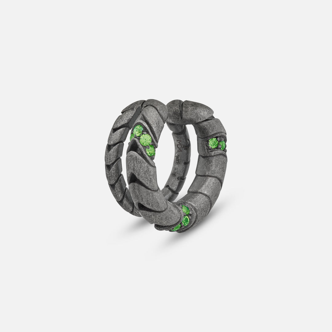 Close-up of Iron Snake Pavé Ear Cuff in oxidized silver with tsavorites.