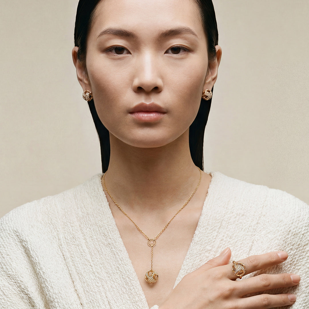 The Explosion Of Joy Grand Pendant in 18K yellow gold showcases pavé-set white diamonds totaling 0.64 carats
