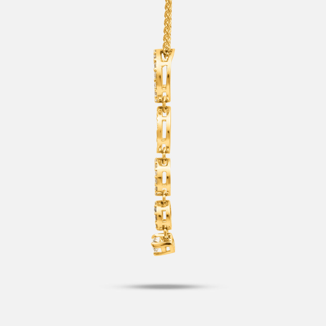 Side view of the Frammenti Cascade Pendant in matte 18K yellow gold, featuring linked segments accented with white diamonds.