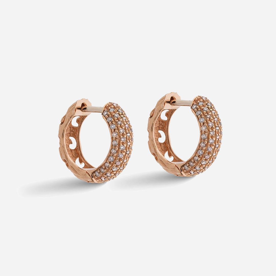 Rose gold hoop earrings with embedded stones on a light gray background