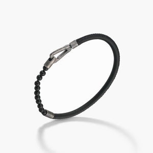 Black beaded bracelet with silver clasp on a white background