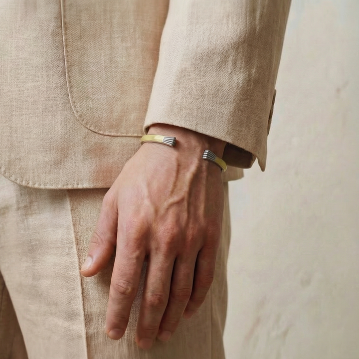 Close-up of a person wearing a beige suit with a neutral background