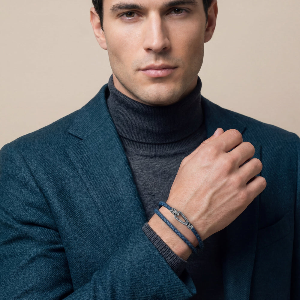 Man wearing a dark blue coat and turtleneck with a beige background