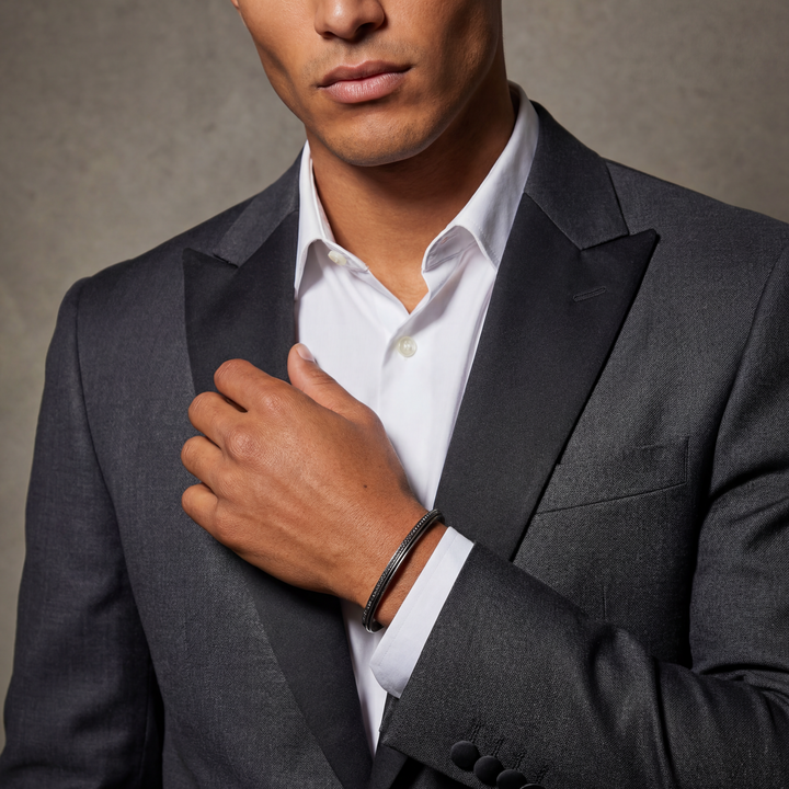 Man wearing a gray suit and white shirt against a neutral background