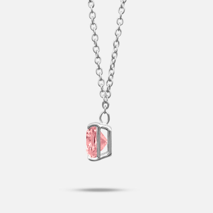 Pink lab grown diamond and platinum setting shown at a slight angle on Eclipse Celeste Pendant