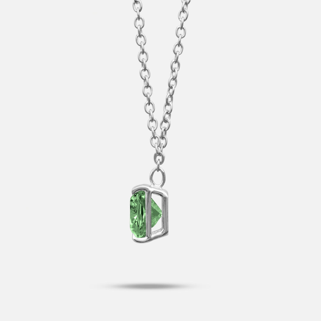 Green lab grown diamond and platinum setting shown at a slight angle on Eclipse Celeste Pendant