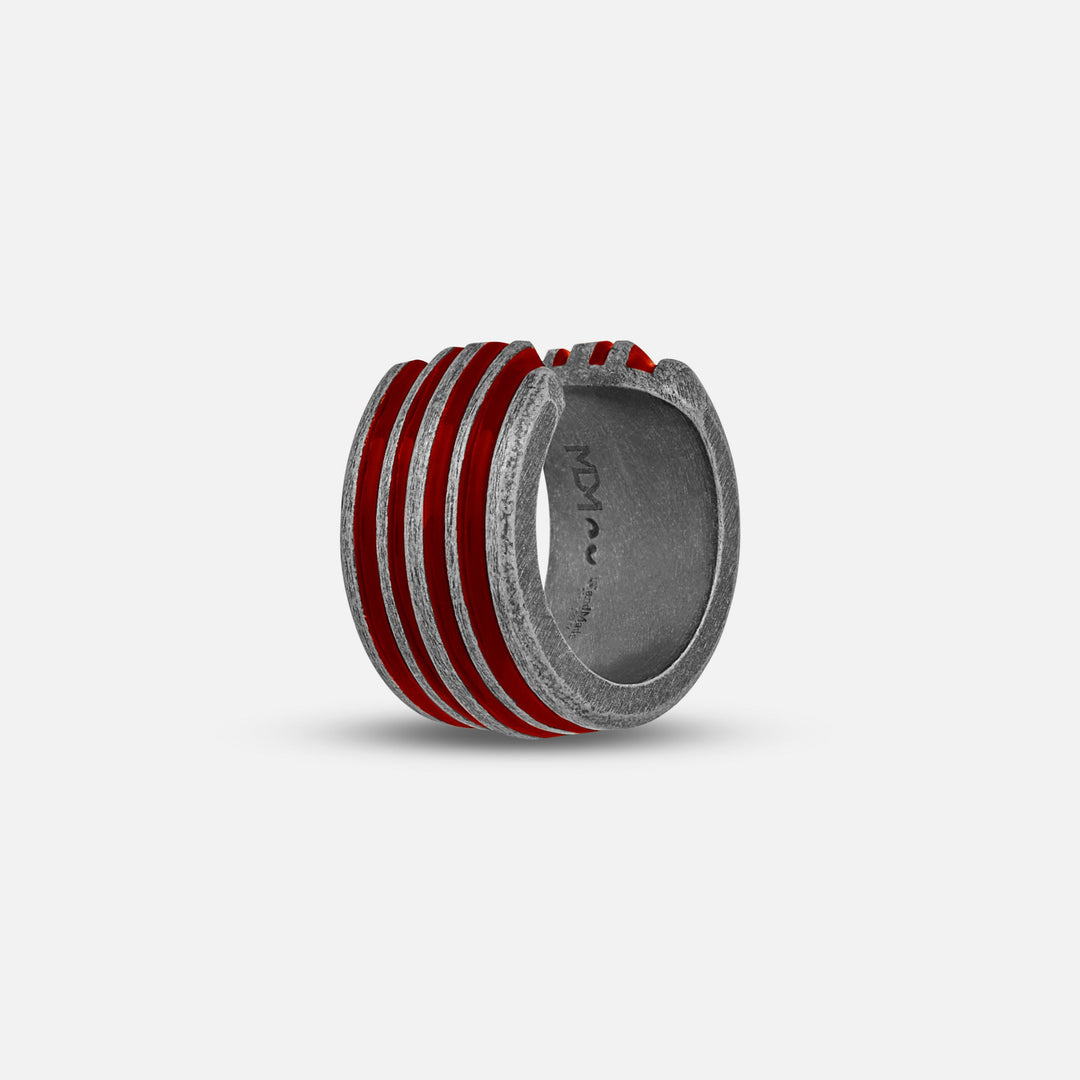 Ring with red and silver design on a light gray background