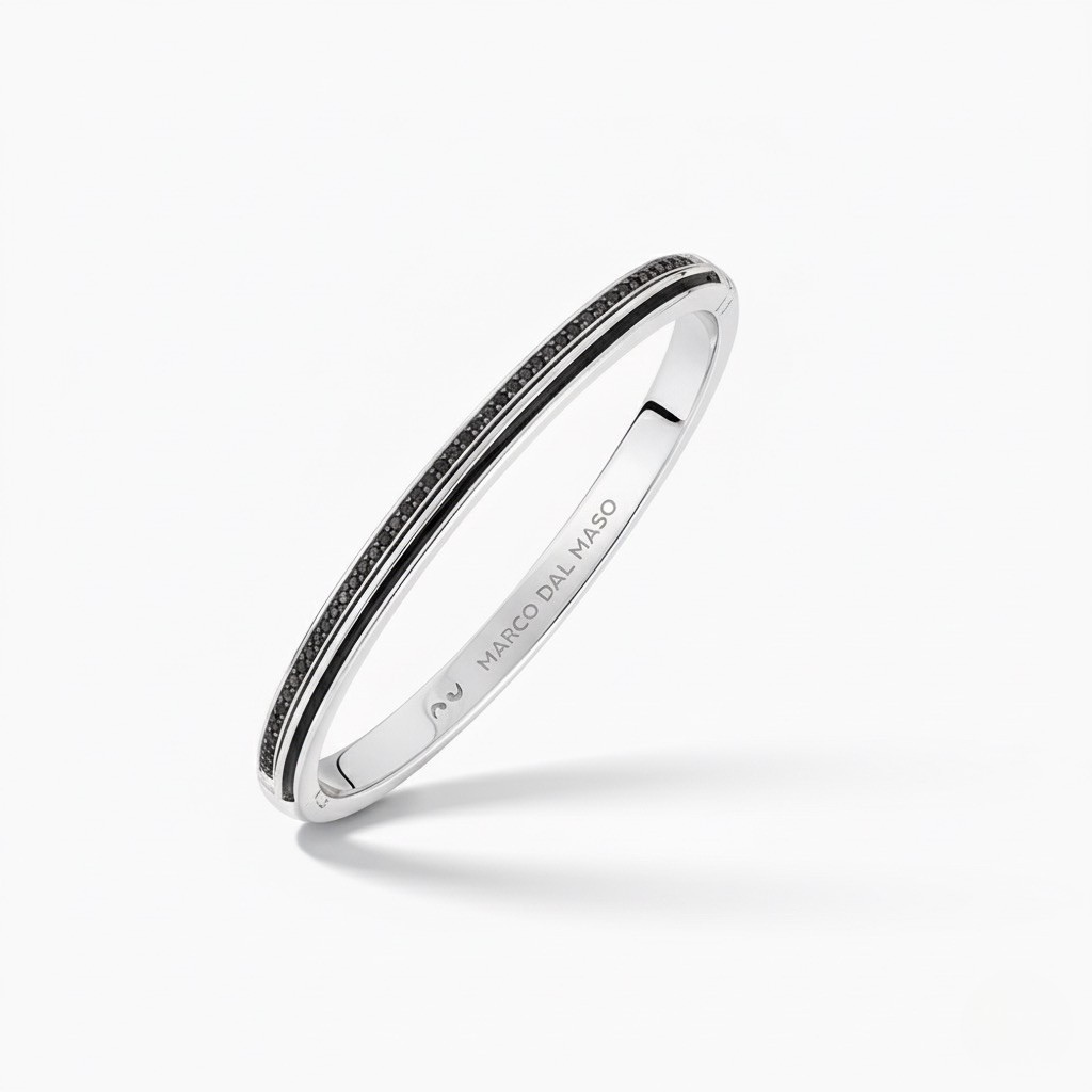 Silver bracelet with black stones on a white background
