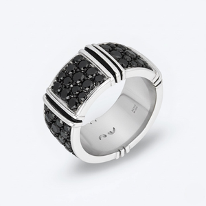 Silver ring with black gemstones on a white background