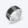Silver ring with black gemstones on a white background