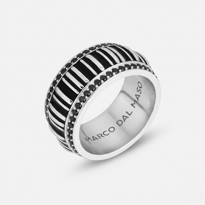 Silver ring with black and white striped design on a white background