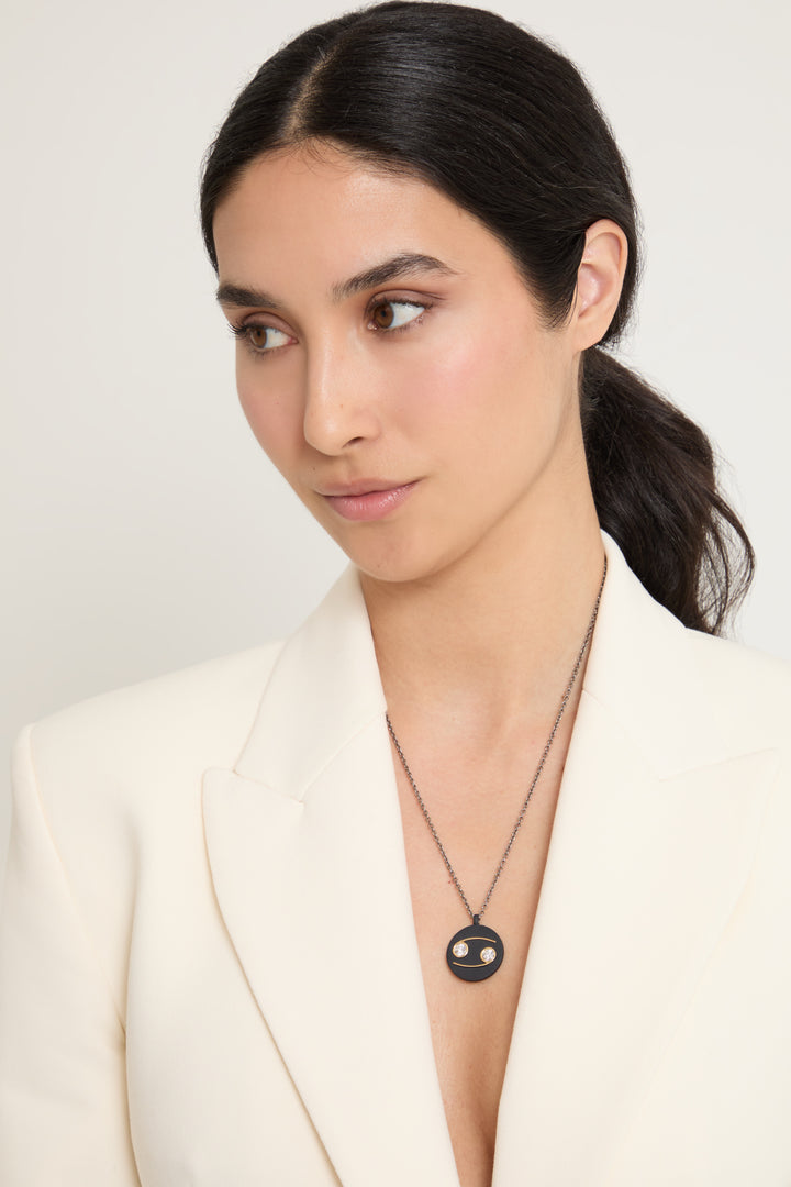 Model wearing Eclipse Cancer Pendant shown in styled position
