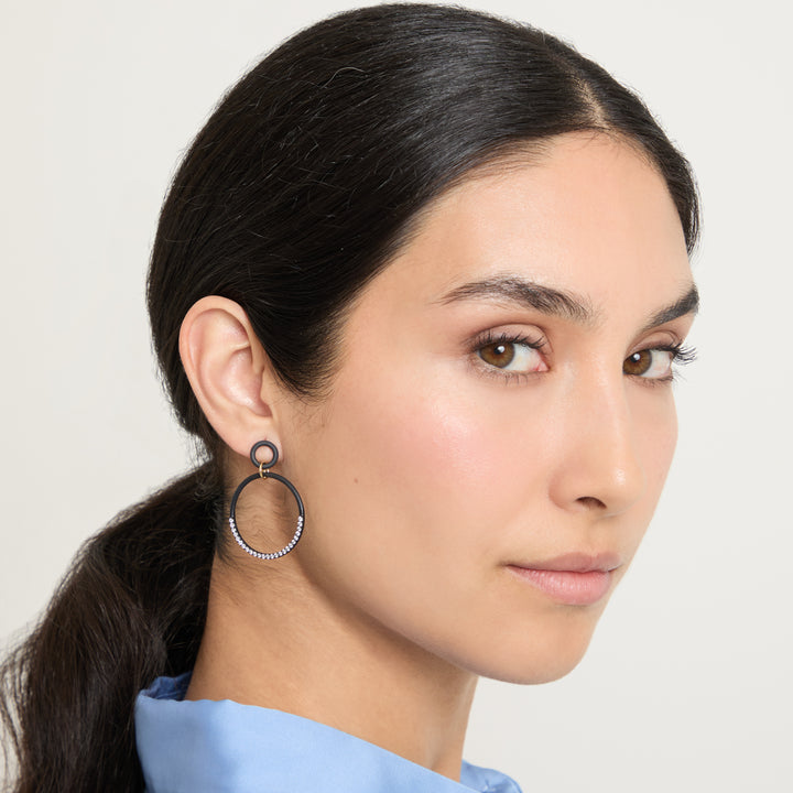 Model wearing Eclipse Twin Orbit Earrings shown in styled position