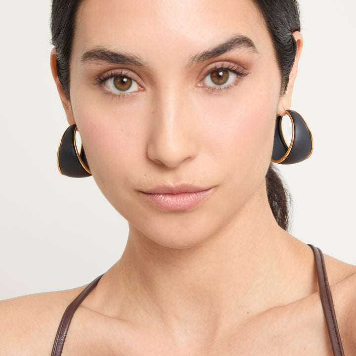 Model wearing Eclipse Wide Dawn Hoops shown in styled position