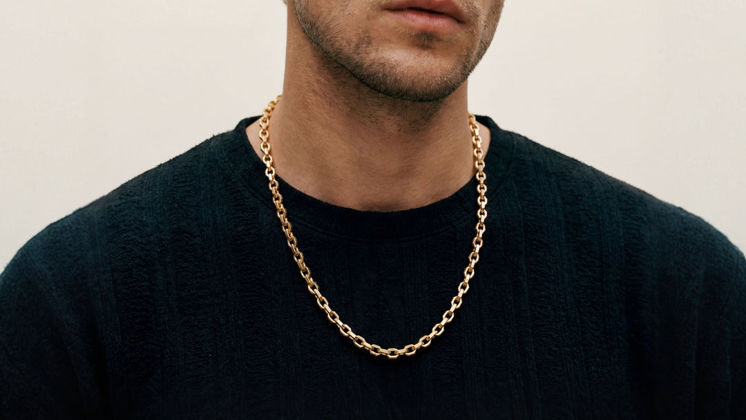 Ulysses Faceted Chain in matte 18k yellow gold worn around the neck.